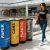 Woman walking passed elegant recycling bins in a mall